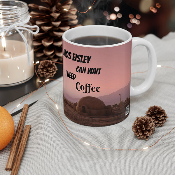 Mug with 'Mos Eisley can wait, I need coffee' text on a table with decorative items.