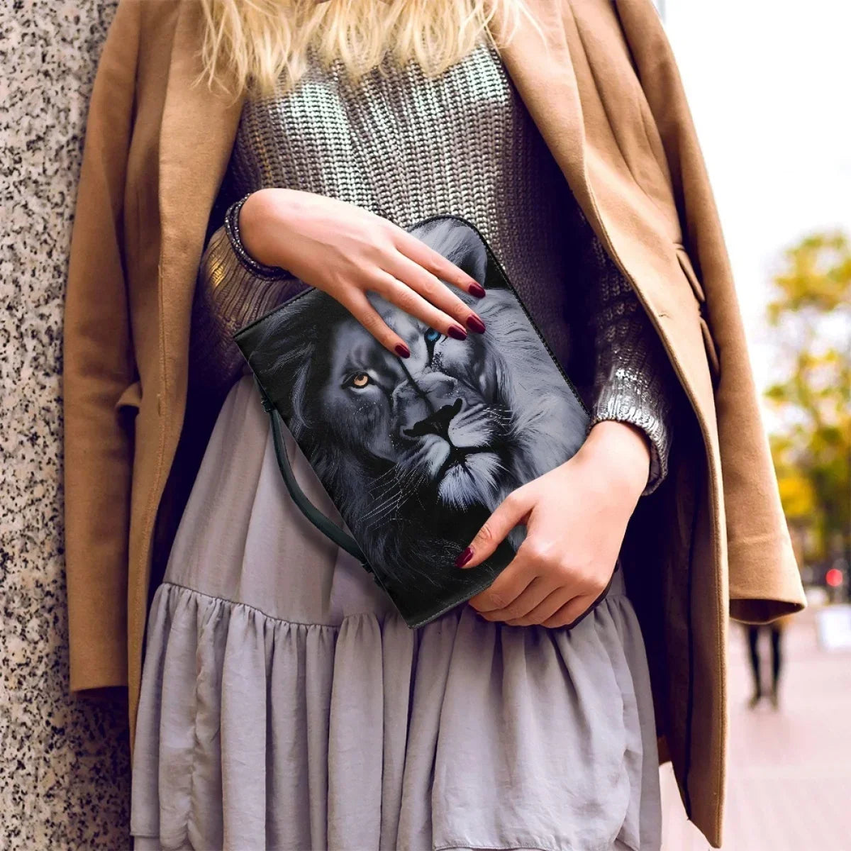 Woman holding a bible with the image of a lion's Head